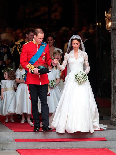 Prince William and Kate Middleton leaving abbey on wedding day, Kate wears lace long sleeve wedding dress with A-line skirt